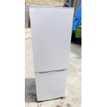 A tall fridge freezer, in silvered finish, 143cm high.