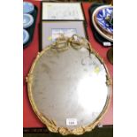 A group of prints and a mirror, the early 20thC gilt framed mirror with bow top, on a battleship pos