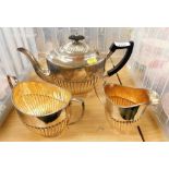 A silver plated three piece tea service, part fluted decoration, comprising tea pot, milk jug, and s
