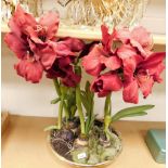 An artificial flower group in gold painted bowl.