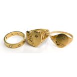 Three 9ct gold dress rings, to include a 9ct gold shield shaped dress ring, with scroll and carved s