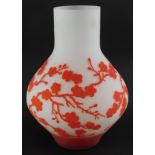 An acid etched art glass vase, decorated with red flowering prunus on a white ground, in the manner