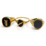 Three 9ct gold signet rings, to include one with pierced design shoulders and warrior lava path cent