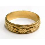 A 9ct gold wedding band, with two row etched design, bearing engraving 5-M 789P, London 1915, ring s