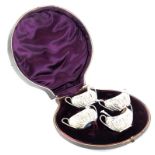 A set of four Victorian two handled salts and spoons, each embossed with scrolls, etc., Birmingham 1