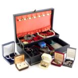 A black jewellery box and contents, comprising cameo type locket pendant, stone set bracelets, brooc