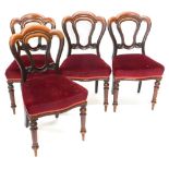 A set of four Victorian mahogany balloon dining chairs, each with a lobed back, a padded seat on tur