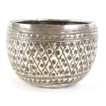 An Eastern metal bowl, with punched or embossed decoration, 3½oz.
