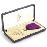 A silver early 20thC silver M.B.E, London 1917, issued in a Garrard and Co. fitted case, with purple