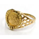 A 9ct gold heart shaped dress ring, the central panel with sovereign type decorated decoration, on a