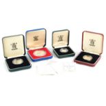 A collection of four silver proof coins, a 1998 two pound coin, a 1995 Second World War two pound p