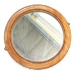 An unusual mahogany wall mirror, the reverse turned with a bullet hole or target decoration, 35cm di