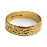 A 9ct gold wedding band, with etched berry and leaf design, Sheffield 1975, ring size P, 2.3g.