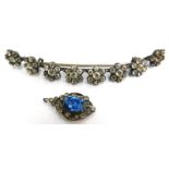 Two items of stone set jewellery, to include a crescent shaped brooch, set with eight floral cluster