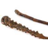 A late 19th/early 20thC bamboo sword stick, 78cm long, and a walking stick carved from a root, possi