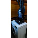 A Logik L612WM16 washing machine, and an Electrolux upright vacuum cleaner. (2)