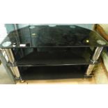 A glass three tier TV stand.