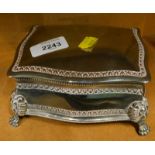 A silver plated lidded casket, on lion head and paw feet, with red velvet lining.