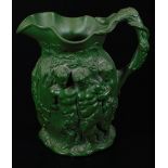 A 19thC Minton type Bacchus and cherub jug, in green glaze, raised with various figures, raised ribb