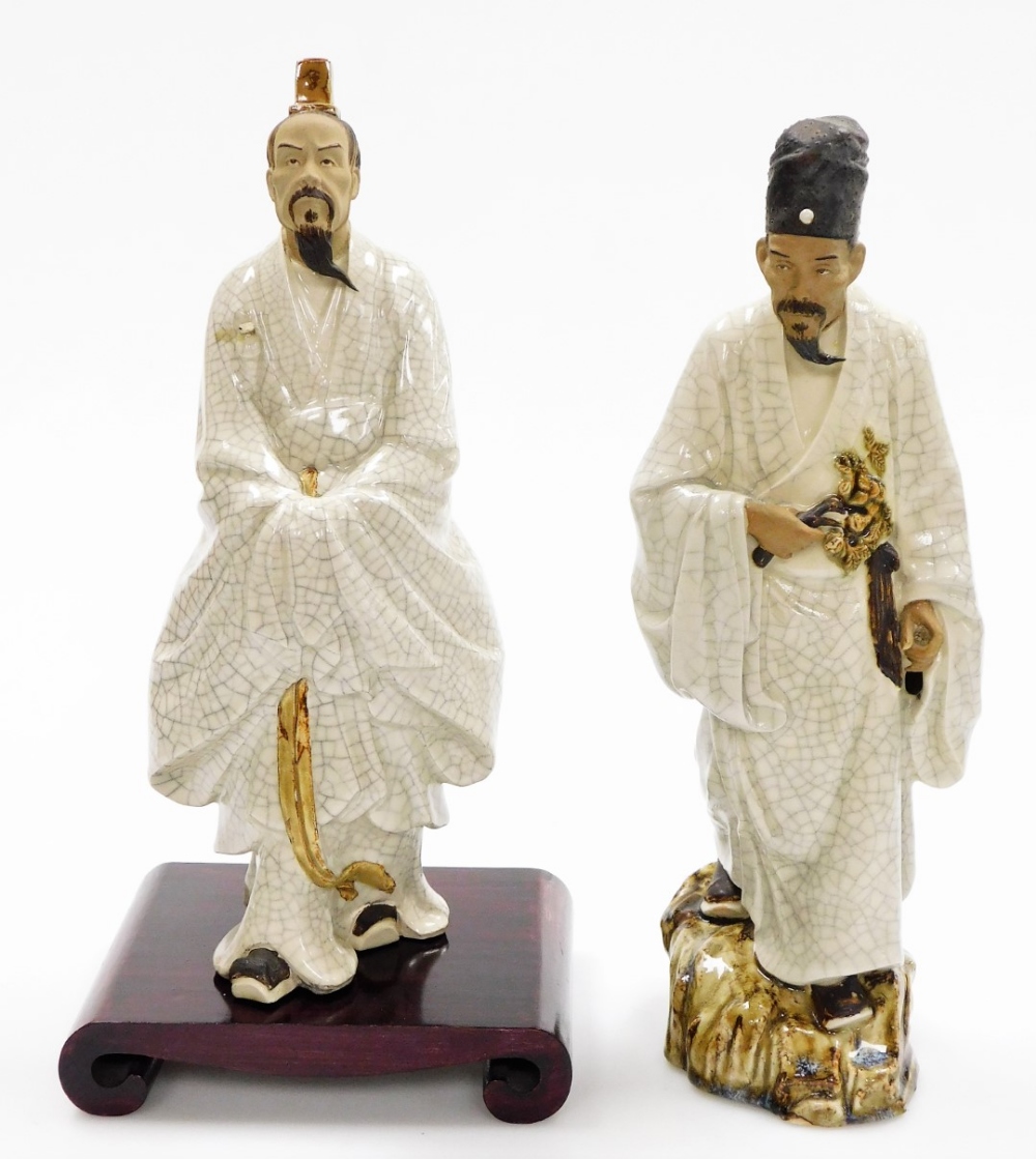 Two Chinese terracotta and white crackle glazed "mudmen" figures, including a figure of a man holdin
