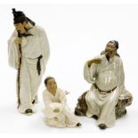 Three terrocotta and white glazed finished figures, to include a figure of a gentleman carrying staf