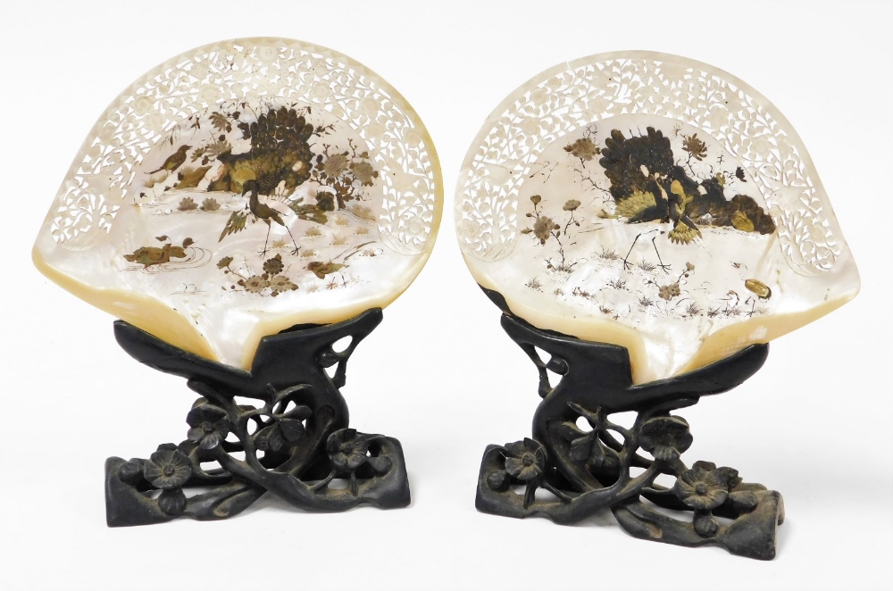 A pair of Chinese pierced and carved mother of pearl shells, decorated in lacquer with birds and flo