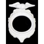 A unmarked Belleek mirror or photograph frame, of circular form surmounted with a Parian eagle with