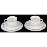 Two Belleek Trios of large cups, saucers and side plates, decorated in the Serenity pattern, the mou