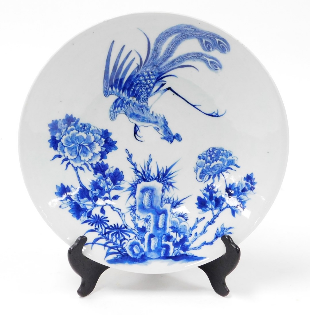 A 19thC Chinese blue and white porcelain charger, with phoenix in flight over peonies, 33cm diameter