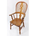A Victorian oak yew and beech Windsor chair, solid saddle seat raised on turned legs, united by an H
