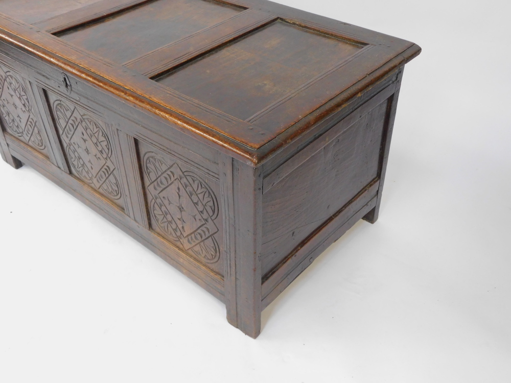An 17thC oak blanket box, with a carved triple panelled front, raised on channeled square legs, 55cm - Image 3 of 6
