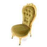 A Victorian parcel gilt balloon back nursing chair, upholstered in green button back velour with ove