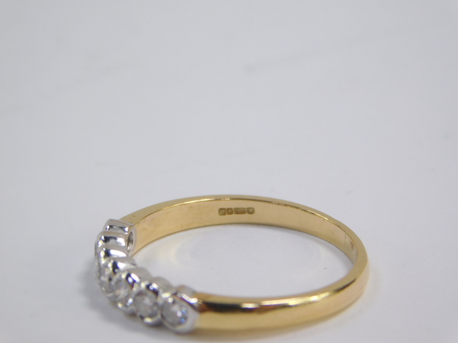 An 18ct gold and diamond seven stone half hoop eternity ring, approx 0.5cts, size Q, 3.7g. - Image 4 of 4