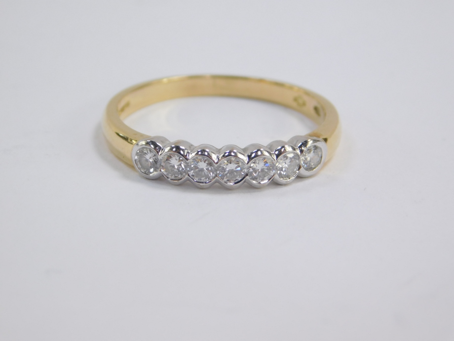 An 18ct gold and diamond seven stone half hoop eternity ring, approx 0.5cts, size Q, 3.7g. - Image 2 of 4