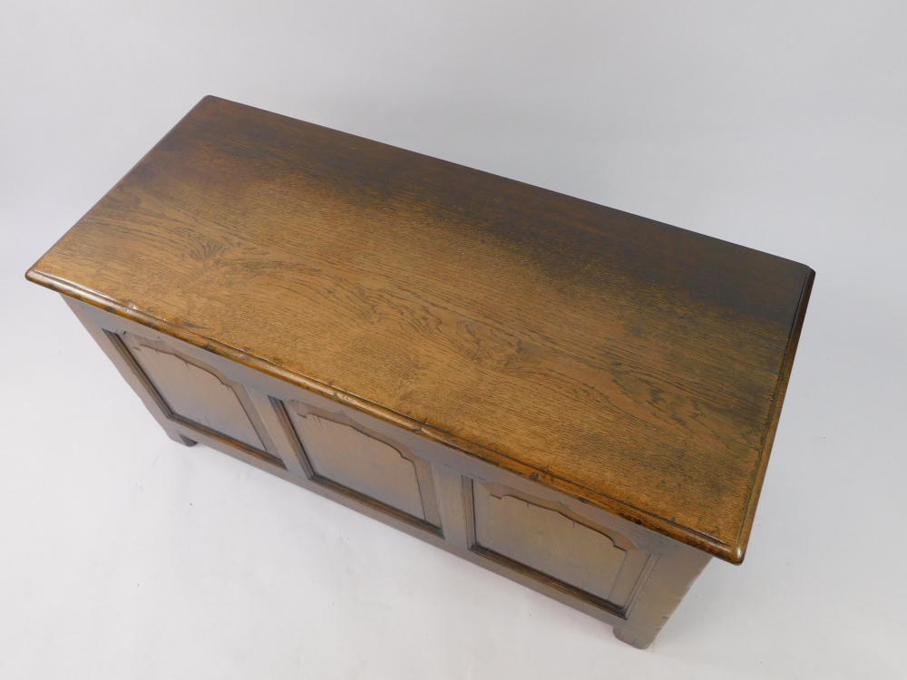 An Old Charm style oak blanket chest, with a triple panelled front, raised on square legs, 53cm high - Image 2 of 3