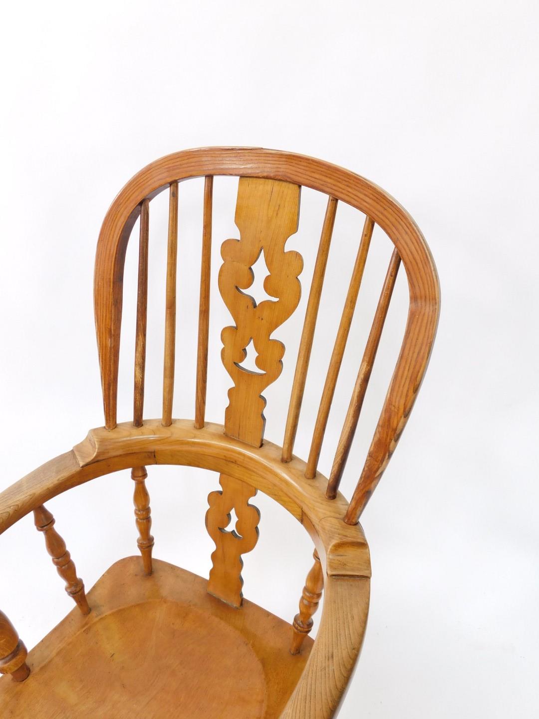 A Victorian oak yew and beech Windsor chair, solid saddle seat raised on turned legs, united by an H - Image 2 of 3