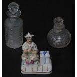 A Continental late 19thC period porcelain figural inkwell, manner of Jacob Petit, modelled with a se