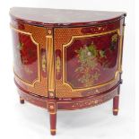 A Chinese red lacquer demi lune side cabinet, painted with birds and flowers, having two doors openi