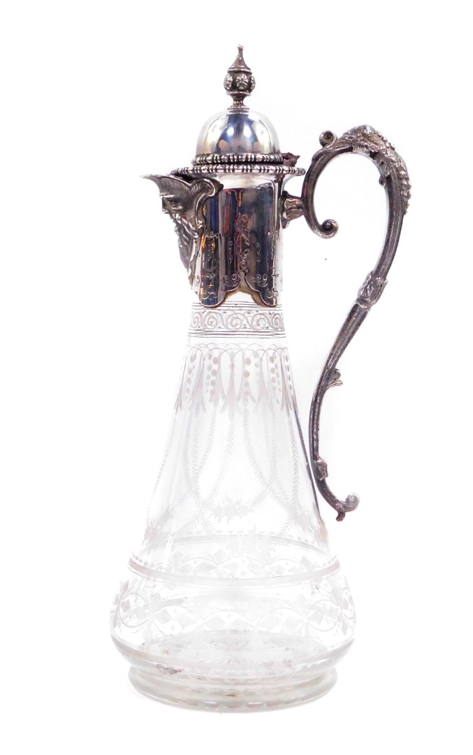 A Victorian cut glass silver plate mounted claret jug, with mask head spout and hinged lid, opening