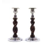 A pair of Art Deco oak and chrome candlesticks, of spiral fluted form, raised on stepped circular ba