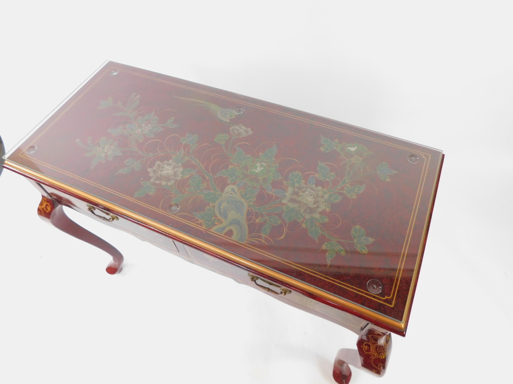 A Chinese painted red lacquer side table, decorated with flowers, with two frieze drawers raised on - Image 2 of 4