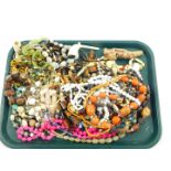 Costume jewellery, decorative necklaces and beads, together with clay pipes. (a quantity)