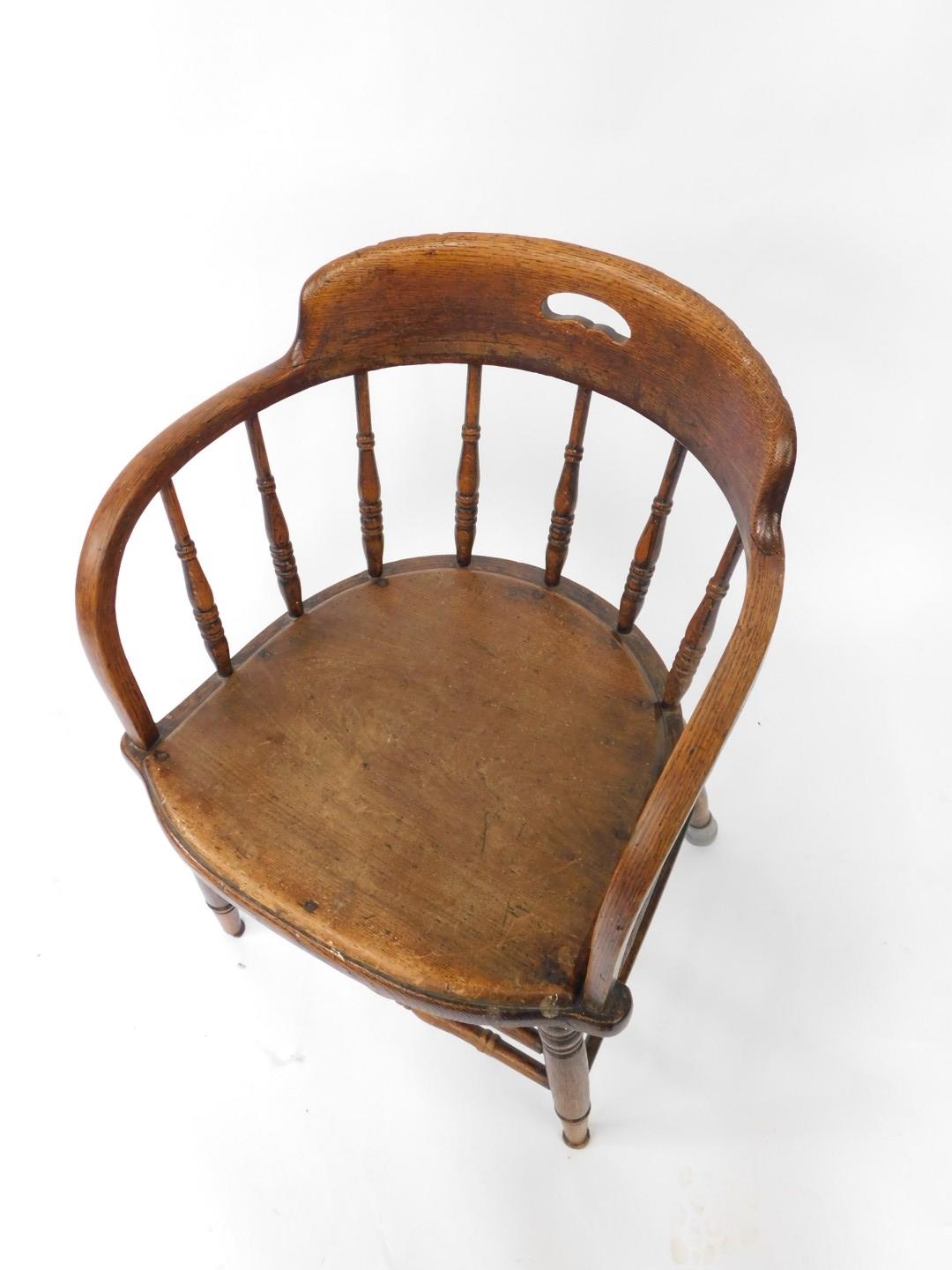 A Victorian oak captain's chair, with a screw down solid seat, raised on turned legs united by turne - Image 2 of 3