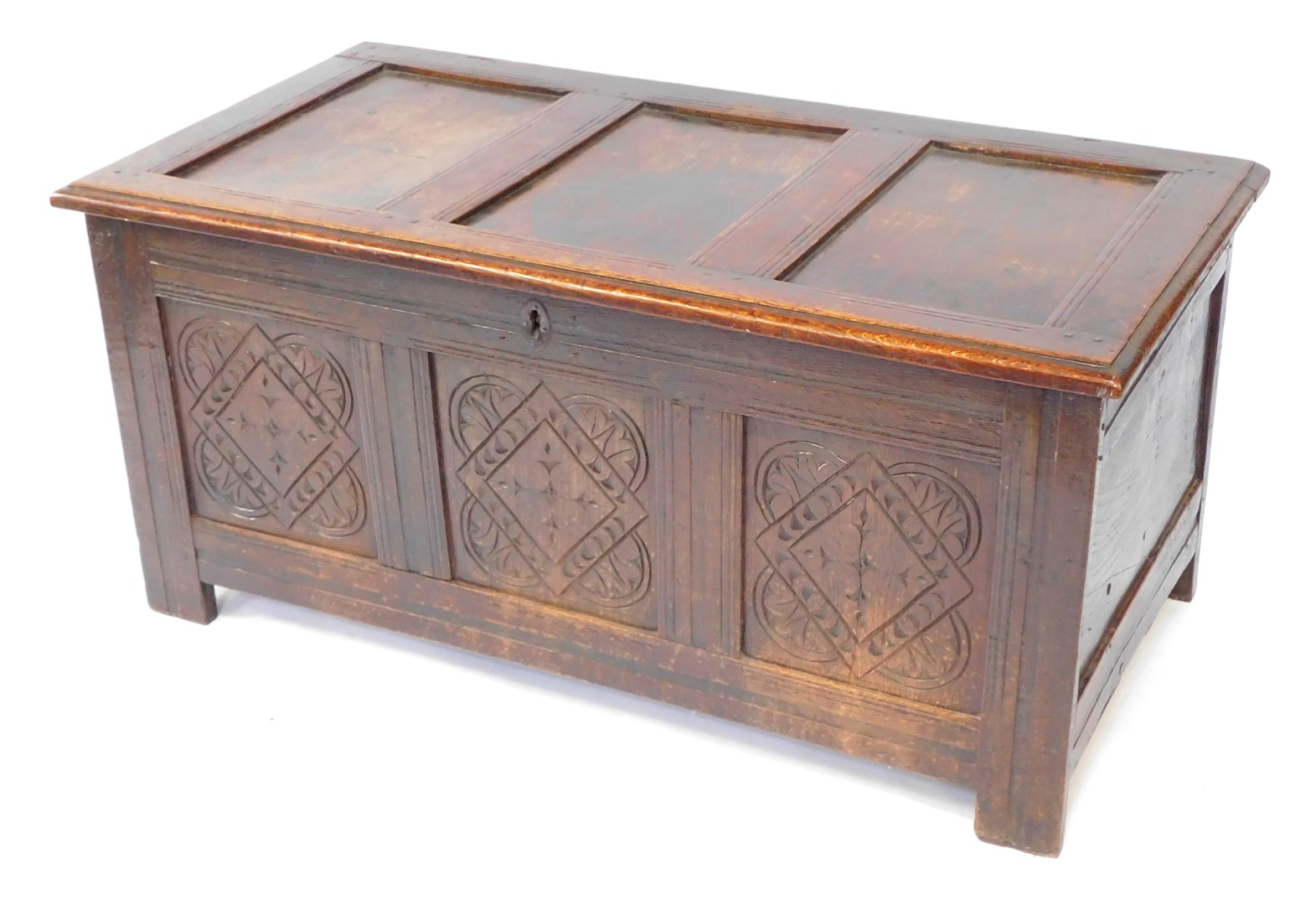 An 17thC oak blanket box, with a carved triple panelled front, raised on channeled square legs, 55cm