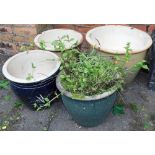 A pair of graduated green glazed stoneware flower pots, 33cm high, a blue glaze flower pot 33cm high