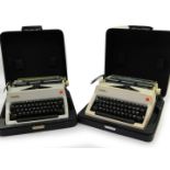 A pair of Olympia typewriters, serial numbers 479943 and 4014630, both cased.