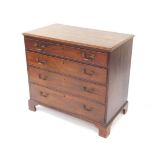 A George III mahogany chest, of four long graduated drawers raised on bracket feet.