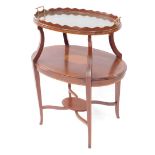 An Edwardian mahogany and satin wood tray top etagere, the brass handled glass bottomed tray above a