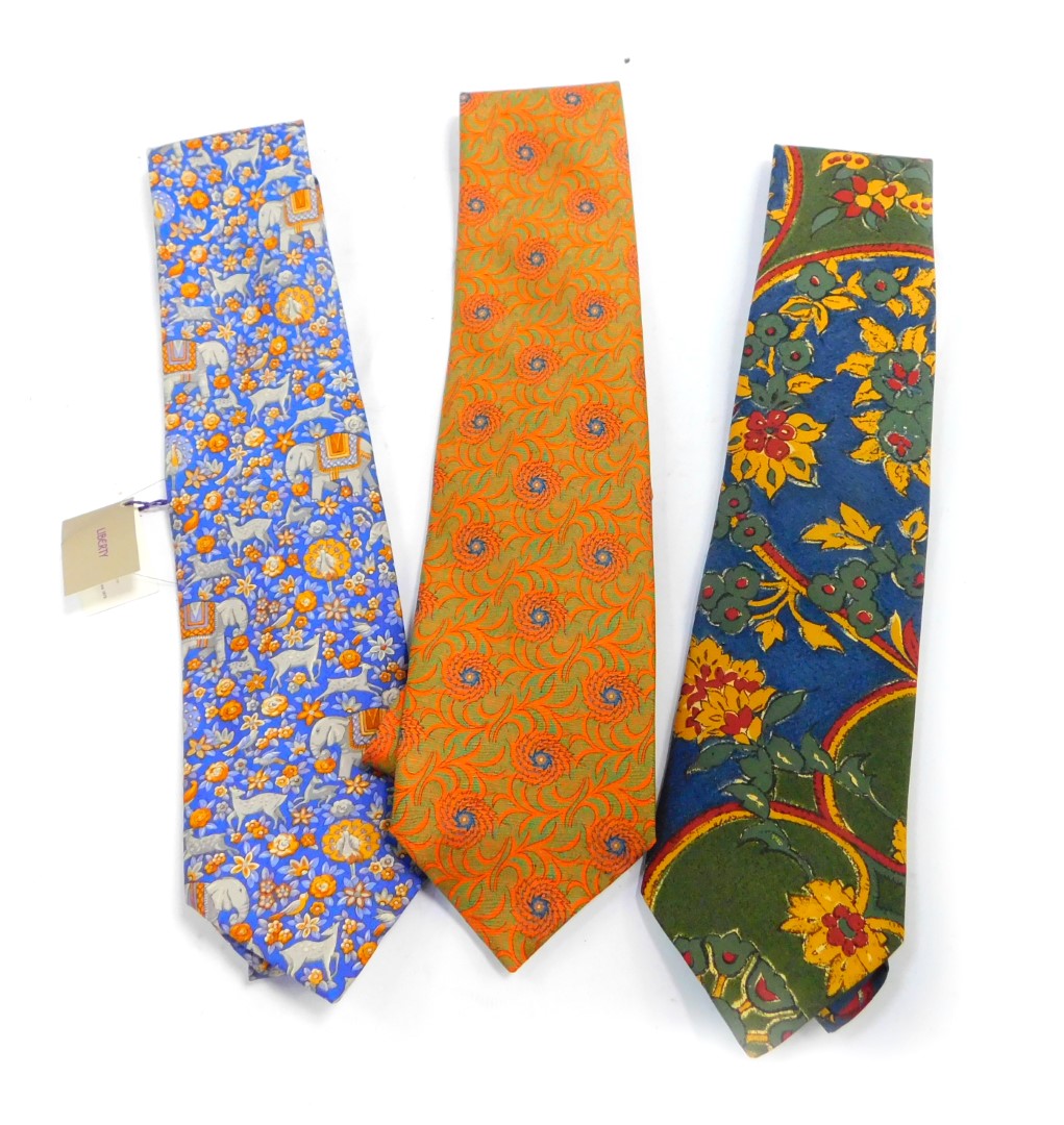 A Liberty blue silk tie, with Indian inspired decoration of animals and flowers, orange and green fl
