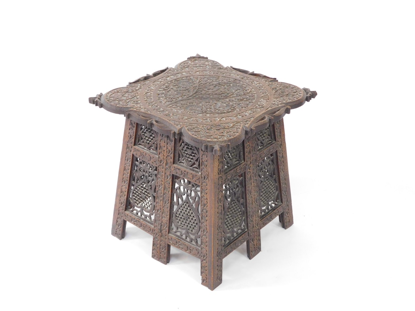 An Indian early 20thC hardwood folding occasional table, the top carved with Arabesques, the sides c - Image 2 of 4